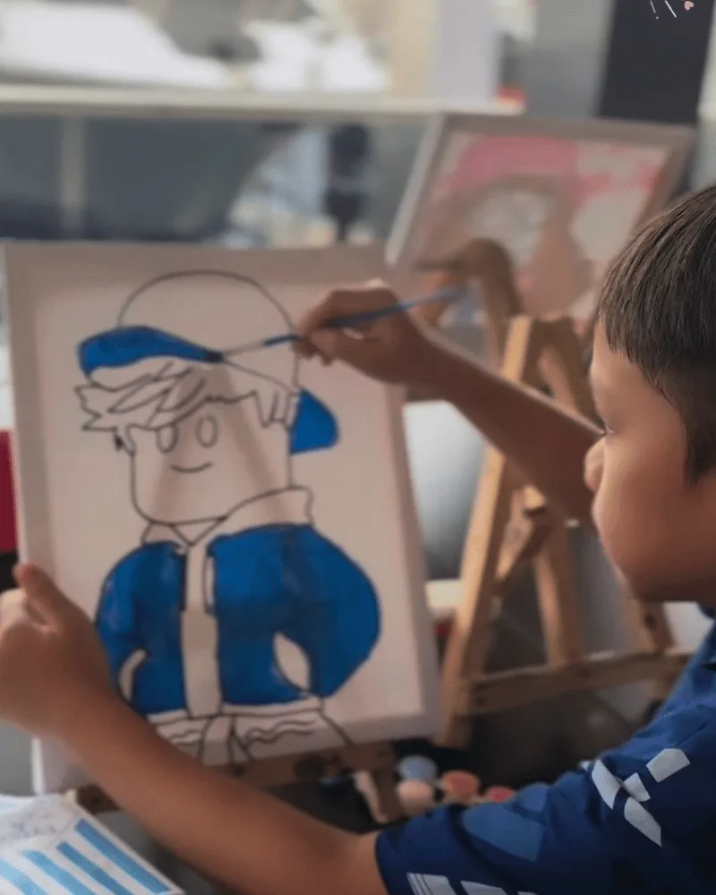 Child creating a canvas painting at UKU Kids Events